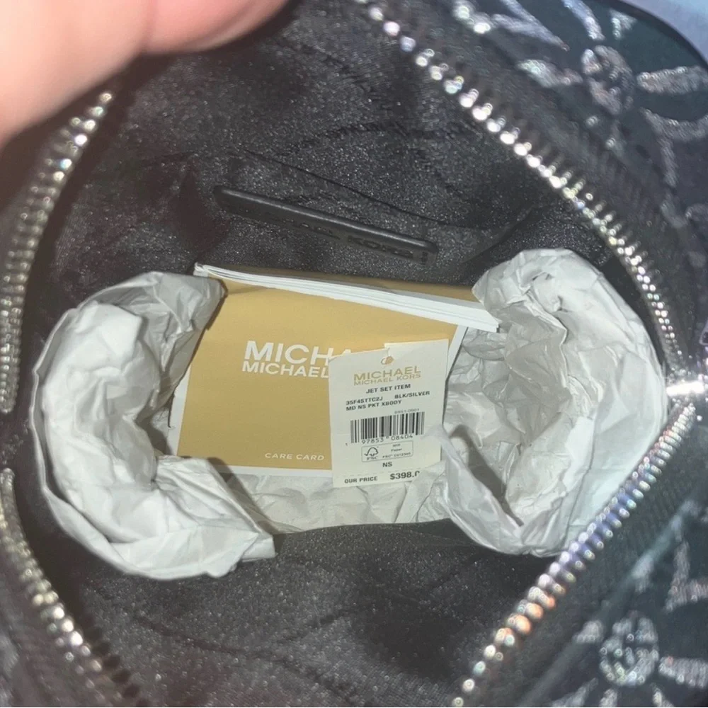 Michael Kors NWT Jet Set black and silver crossbody with guitar strap, NWT